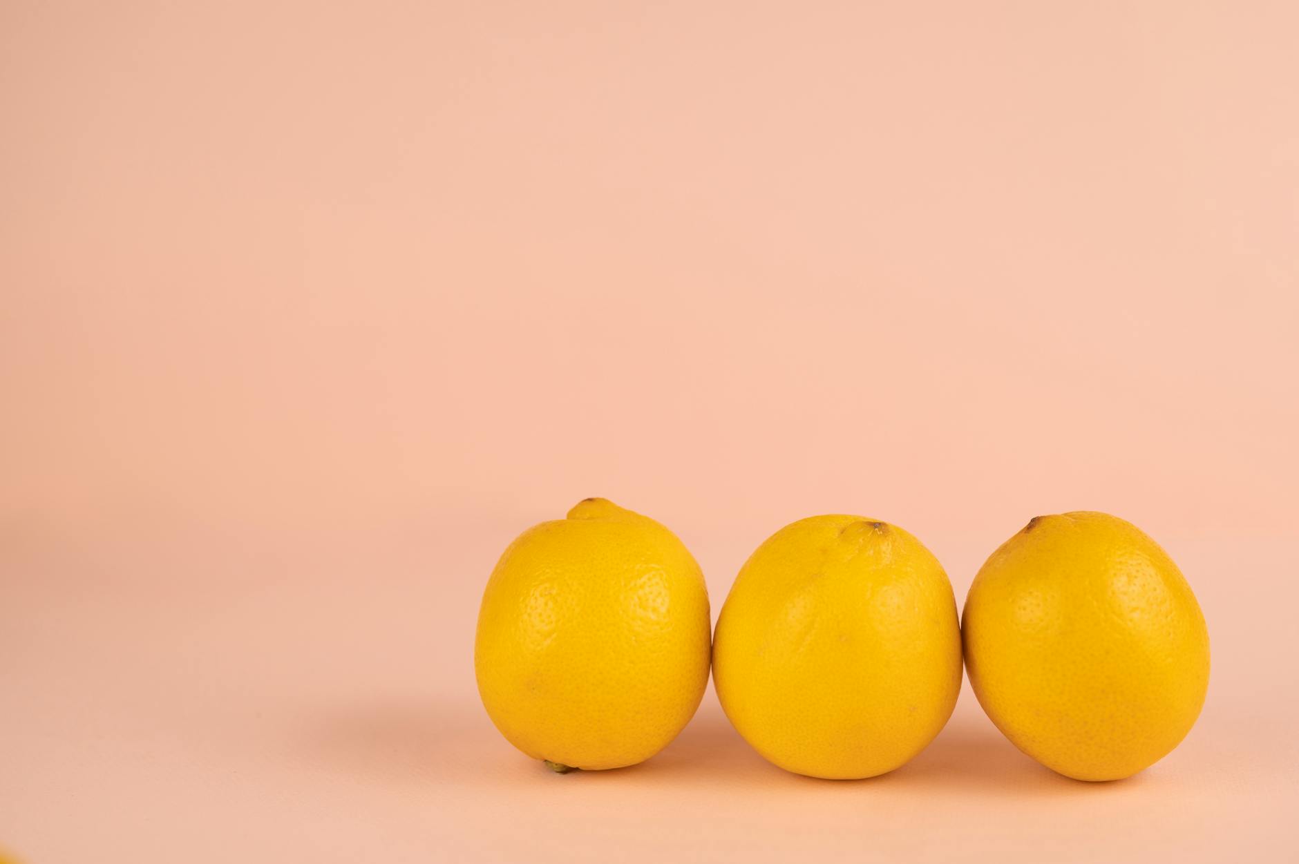 Bright fresh lemons arranged on a pastel background, symbolizing renewal and new approaches to pleasure
